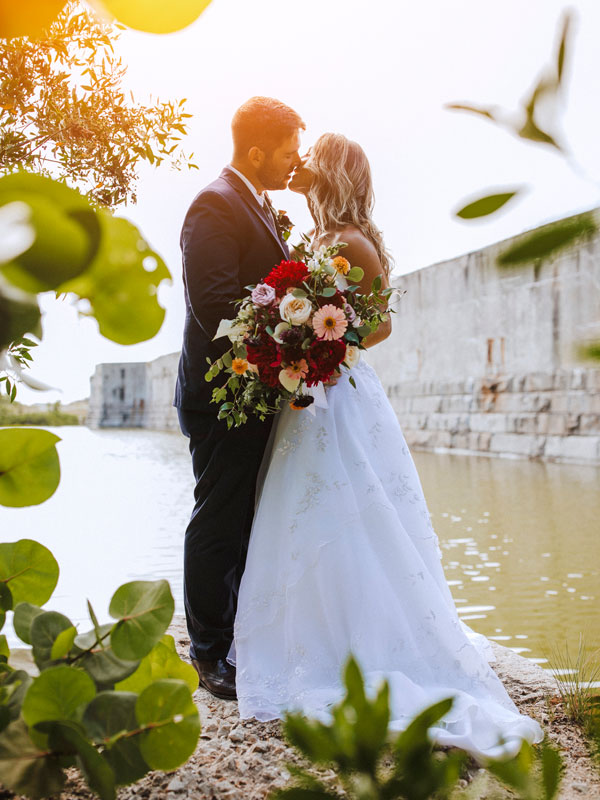 Photo of a groom and bride kissing at Fort Zachary Taylor.